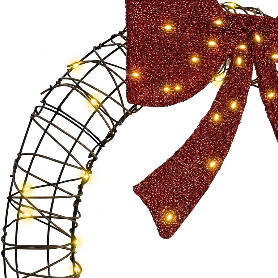 Couronne de Noël lumineuse en rotin avec nœud rouge